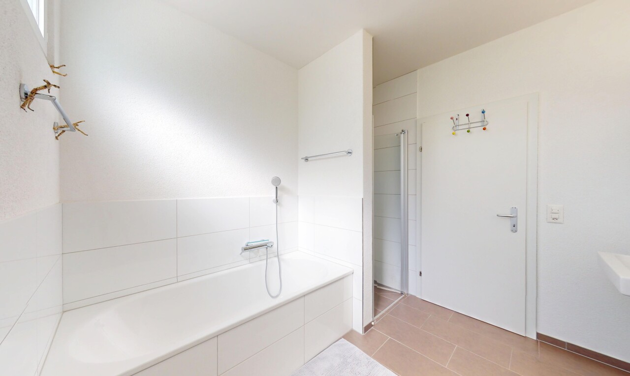full bathroom featuring walk in shower and a bath