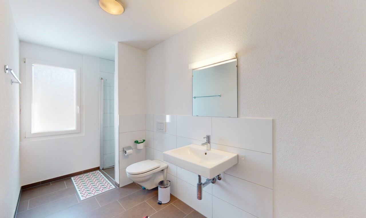 bathroom with a sink, tile patterned floors, a shower stall, and toilet