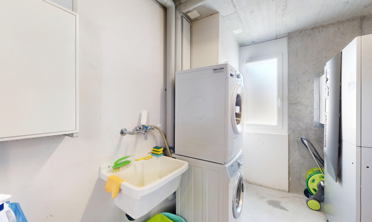 laundry room with stacked washer and dryer and laundry area