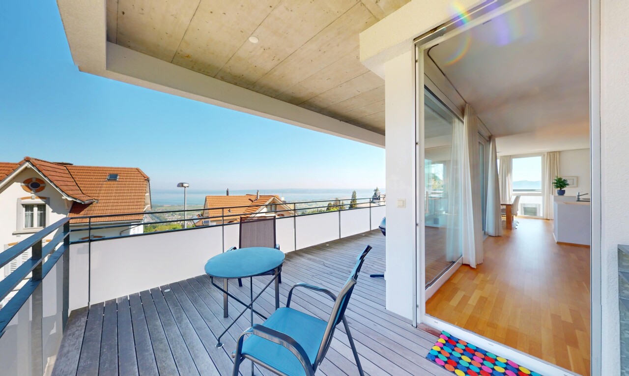 terrace featuring a water view and a balcony