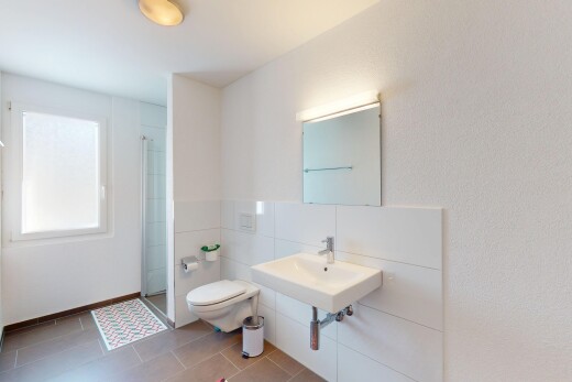 bathroom with a sink, tile patterned floors, a shower stall, and toilet
