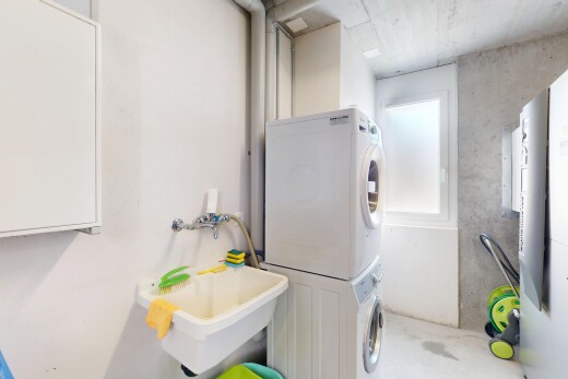 laundry room with stacked washer and dryer and laundry area