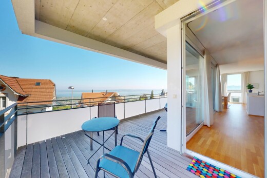 terrace featuring a water view and a balcony