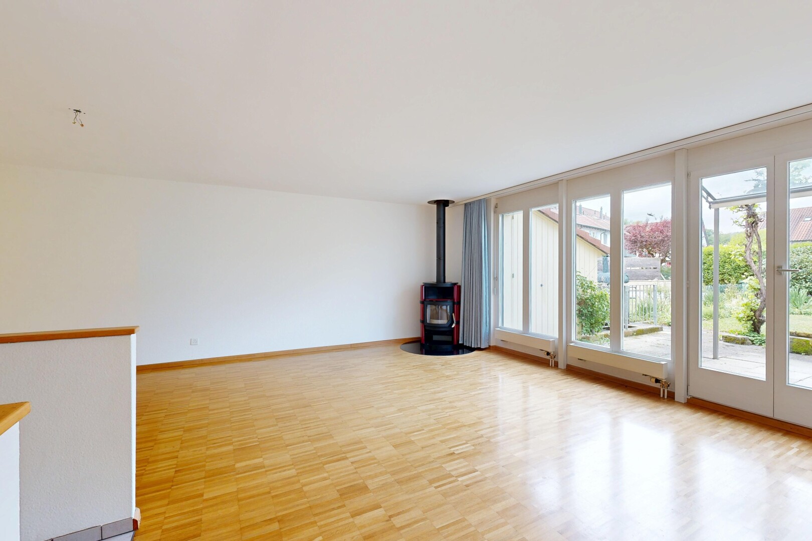 spare room featuring a wood stove and light wood-style flooring