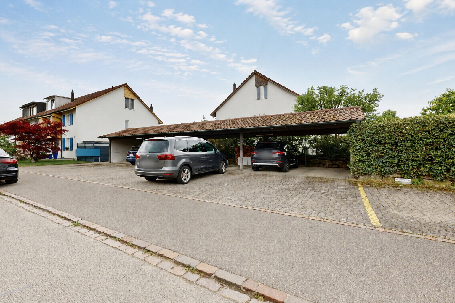 outdoor house featuring covered parking