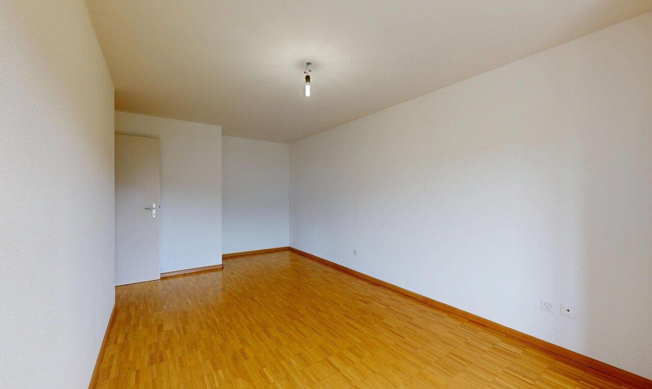 empty room featuring light wood finished floors and baseboards
