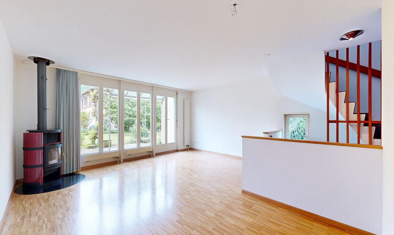 unfurnished room featuring a wood stove, light wood-type flooring, and healthy amount of natural light