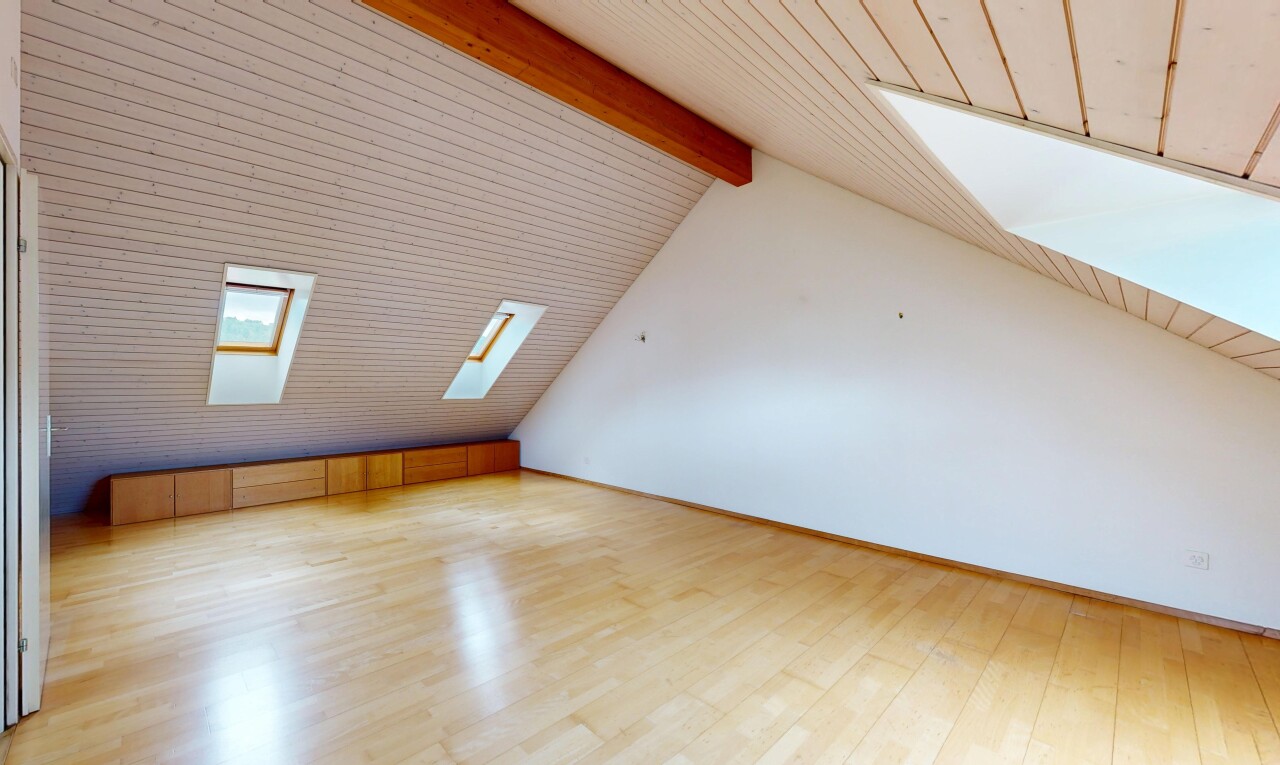 unfurnished room with beam ceiling, light wood-style flooring, and a skylight