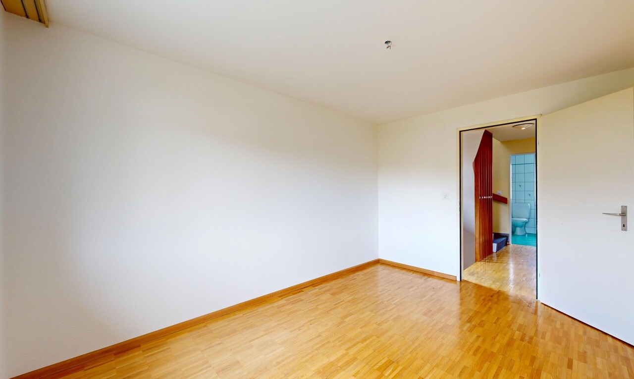 spare room featuring light wood-style flooring and baseboards