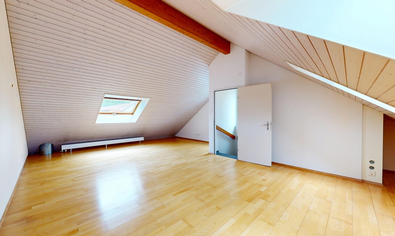 spare room featuring a skylight, light wood-style flooring, a baseboard radiator, vaulted ceiling with beams, and wooden ceiling