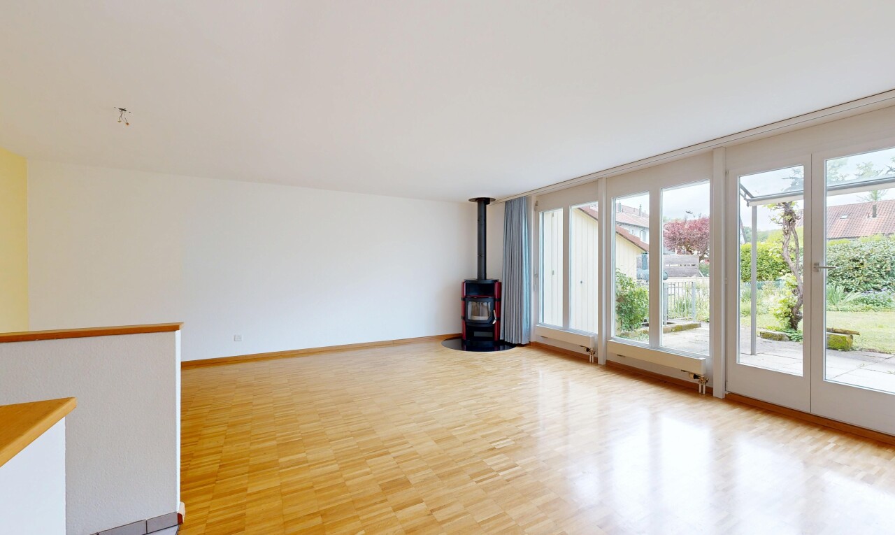 spare room featuring a wood stove and light wood-style flooring