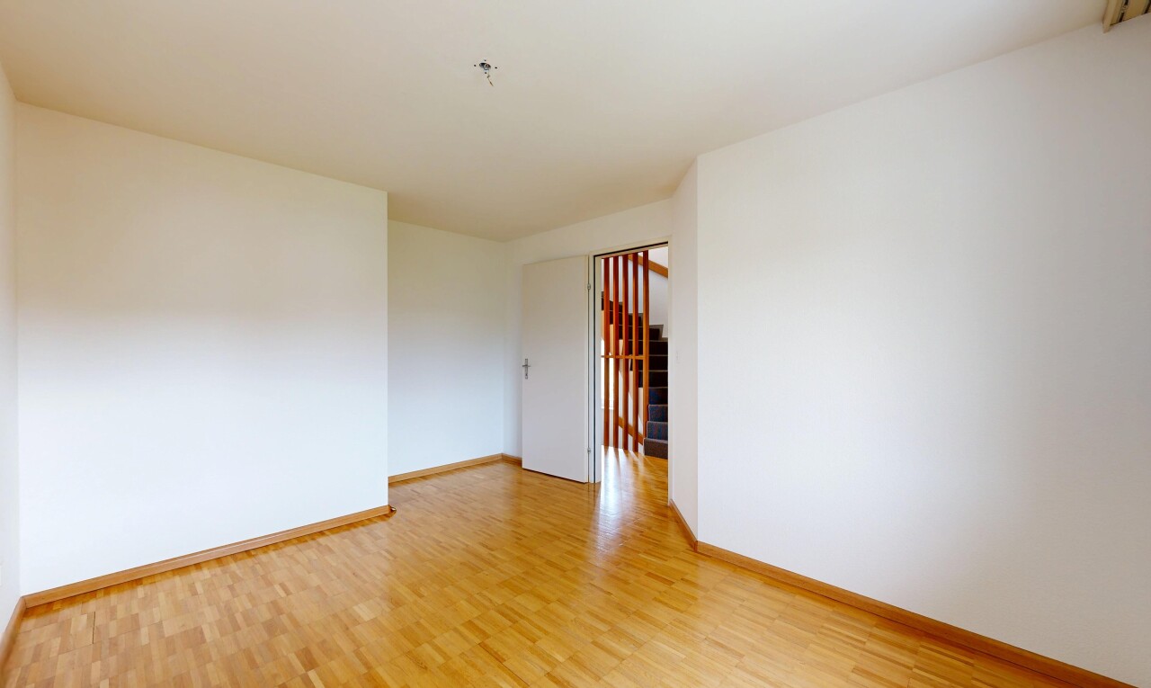 unfurnished room with light wood-style floors and baseboards