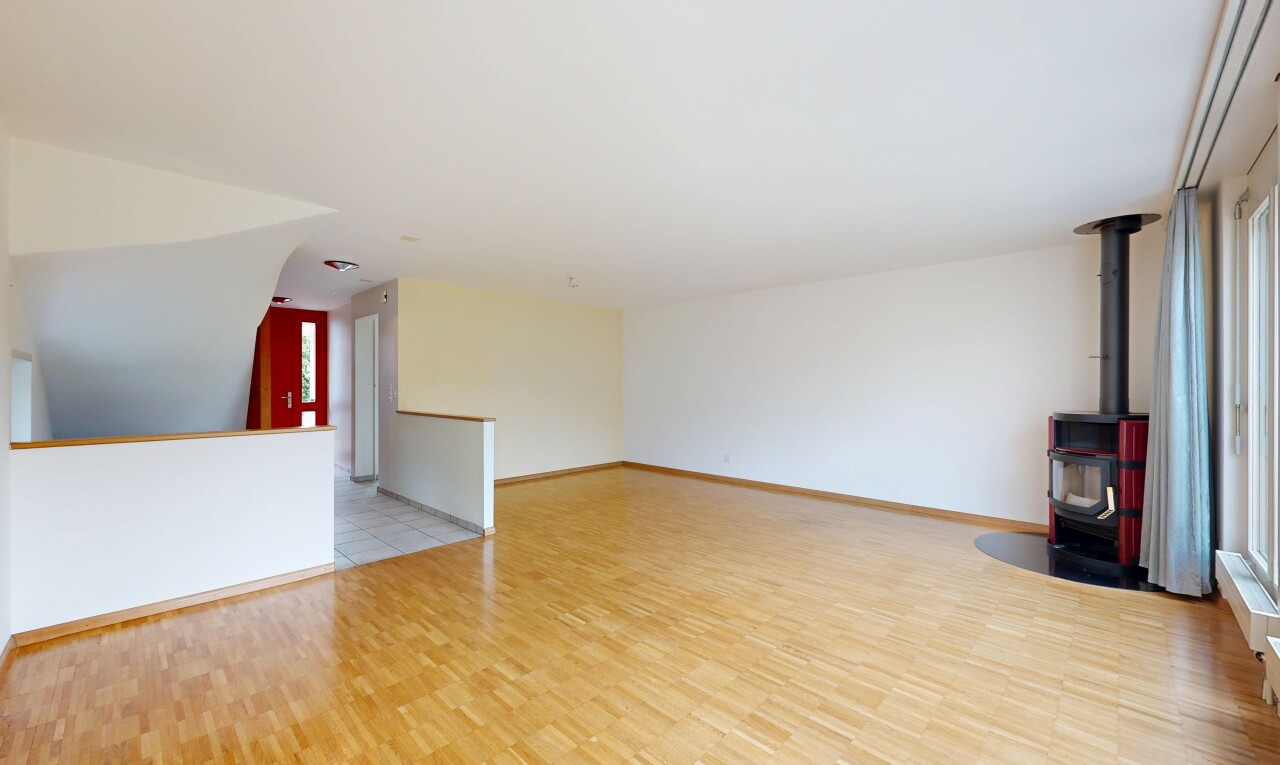 empty room featuring light wood-style floors and a wood stove