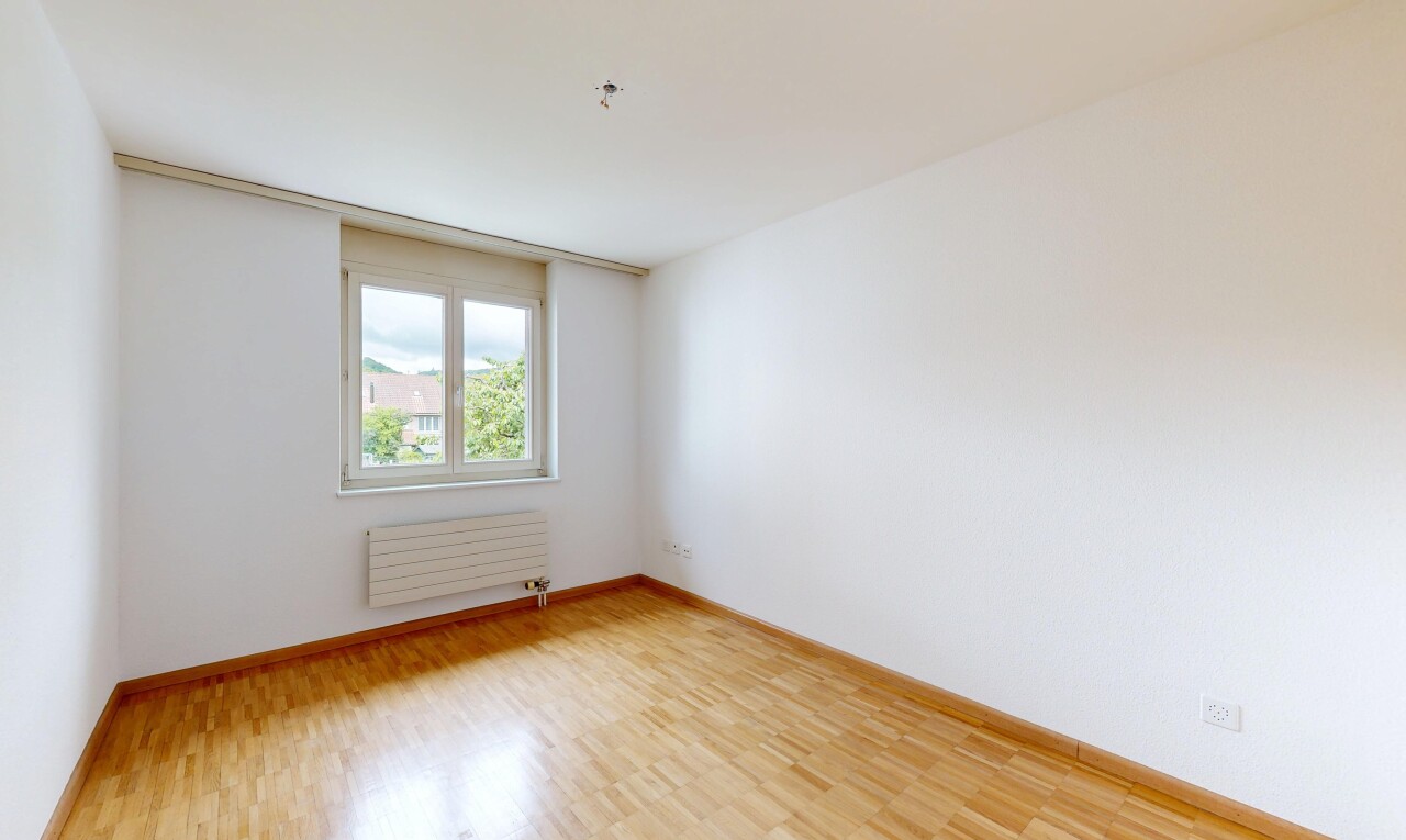 spare room with light wood-type flooring and radiator