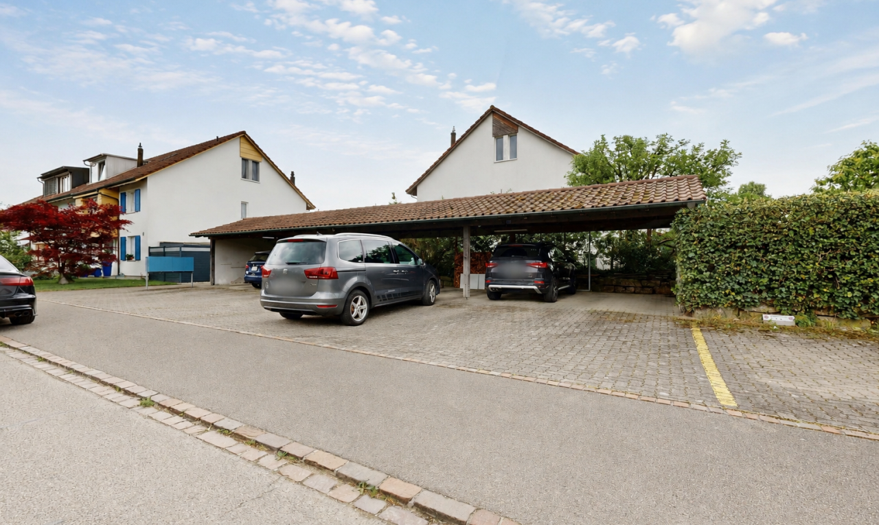 outdoor house featuring covered parking