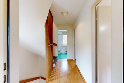 hallway with light wood-style flooring and baseboards