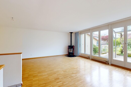 spare room featuring a wood stove and light wood-style flooring