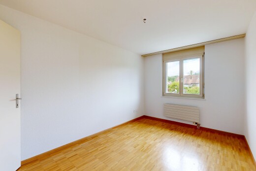 empty room with light wood-type flooring and radiator heating unit