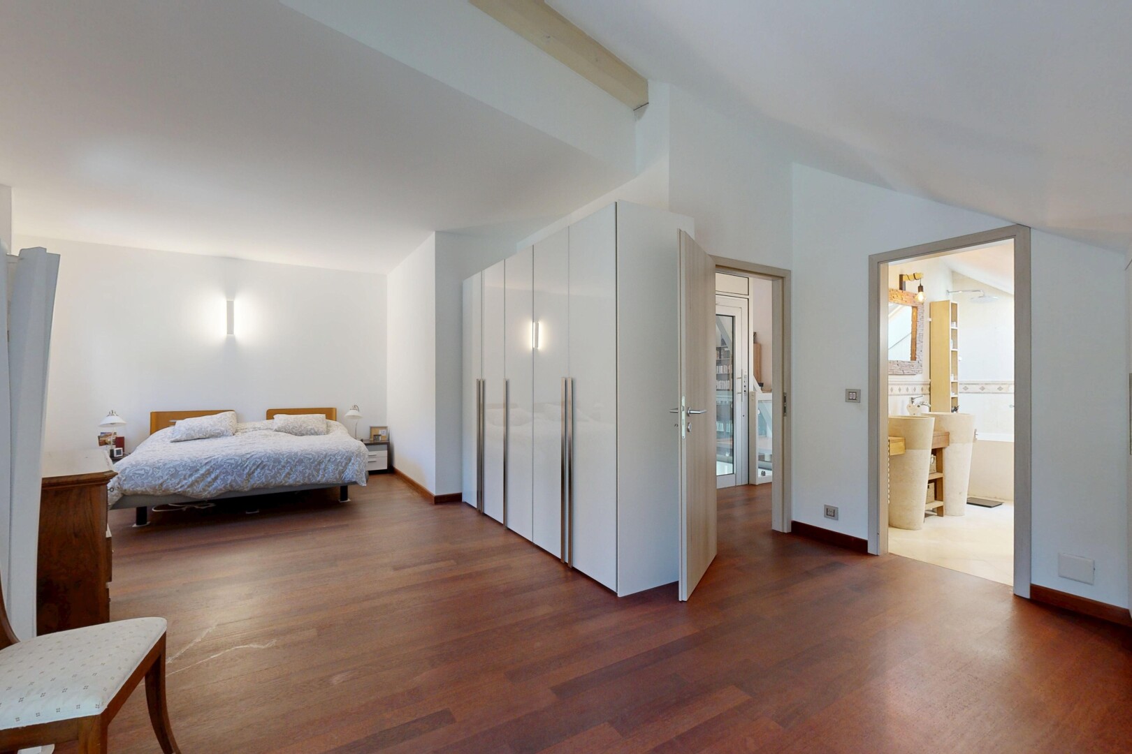 room featuring dark wood-style floors, lofted ceiling, and baseboards