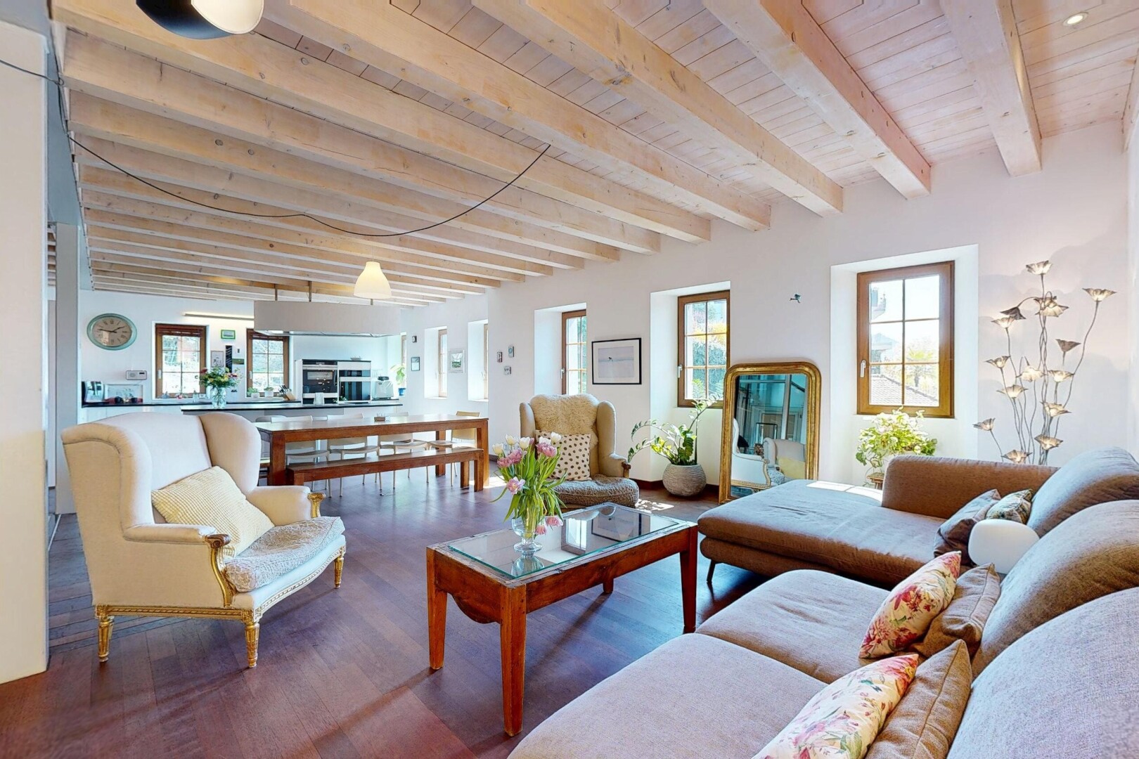 living area featuring wooden ceiling, a healthy amount of sunlight, beamed ceiling, and wood finished floors