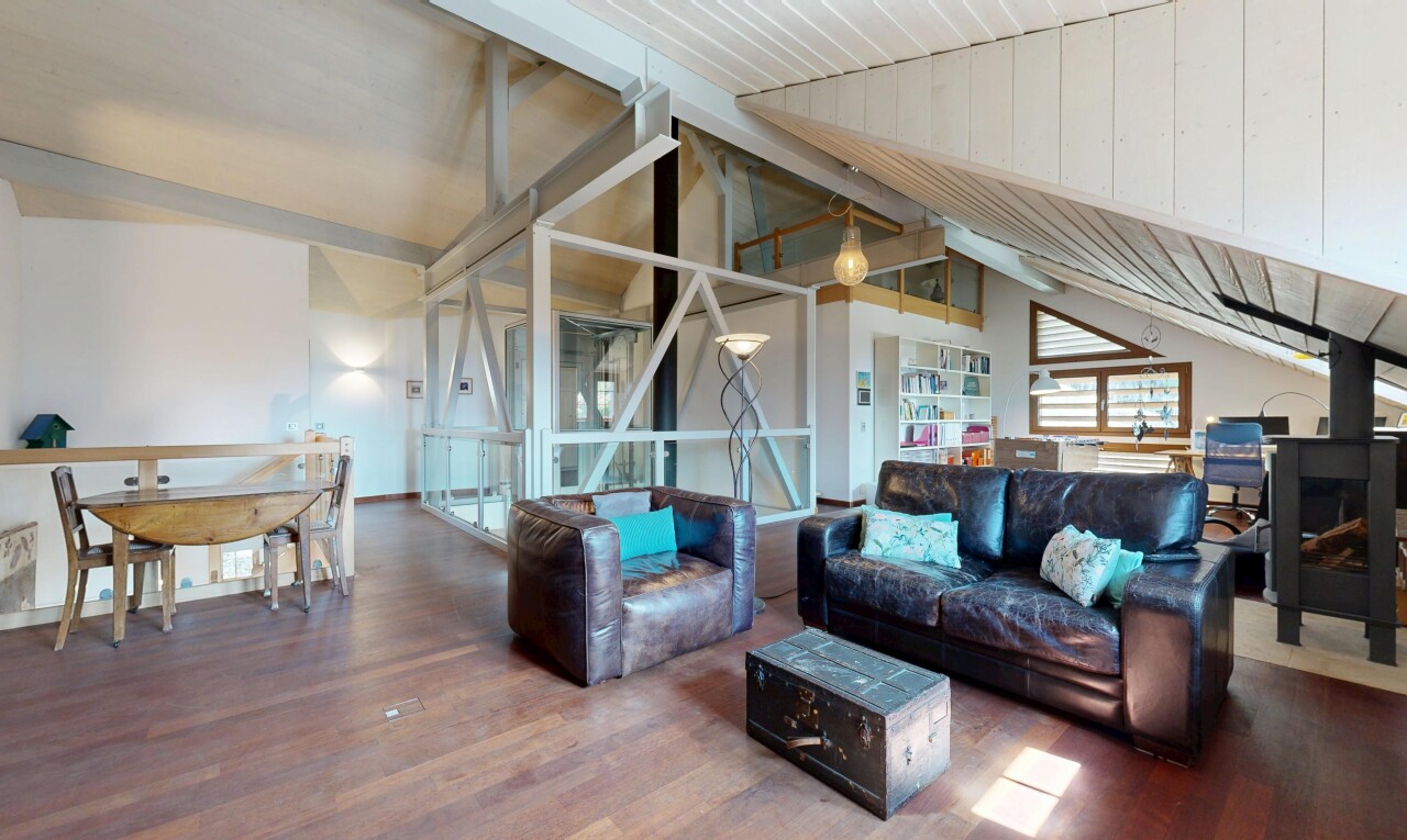 living room with vaulted ceiling with beams and wood finished floors