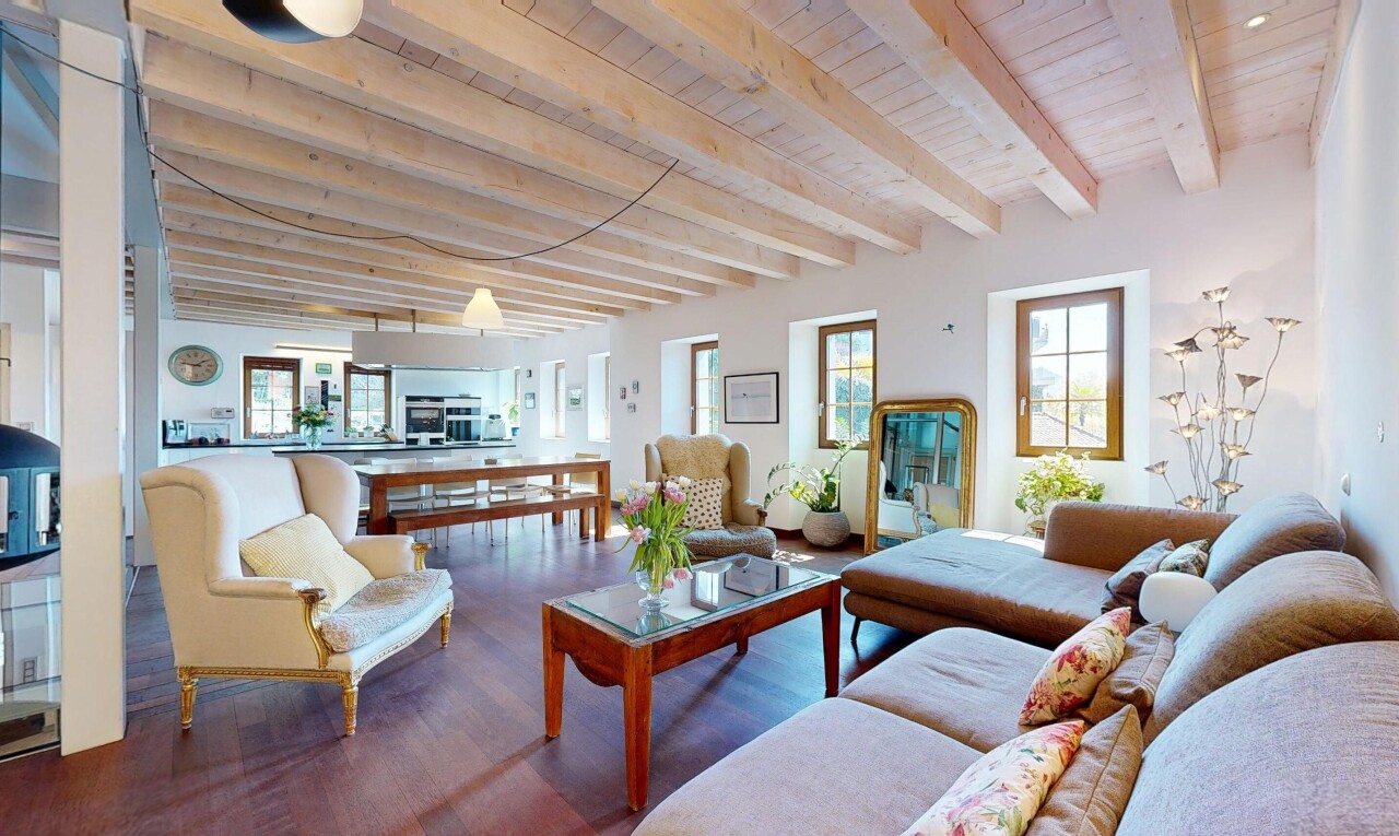 living area featuring wooden ceiling, a healthy amount of sunlight, beamed ceiling, and wood finished floors
