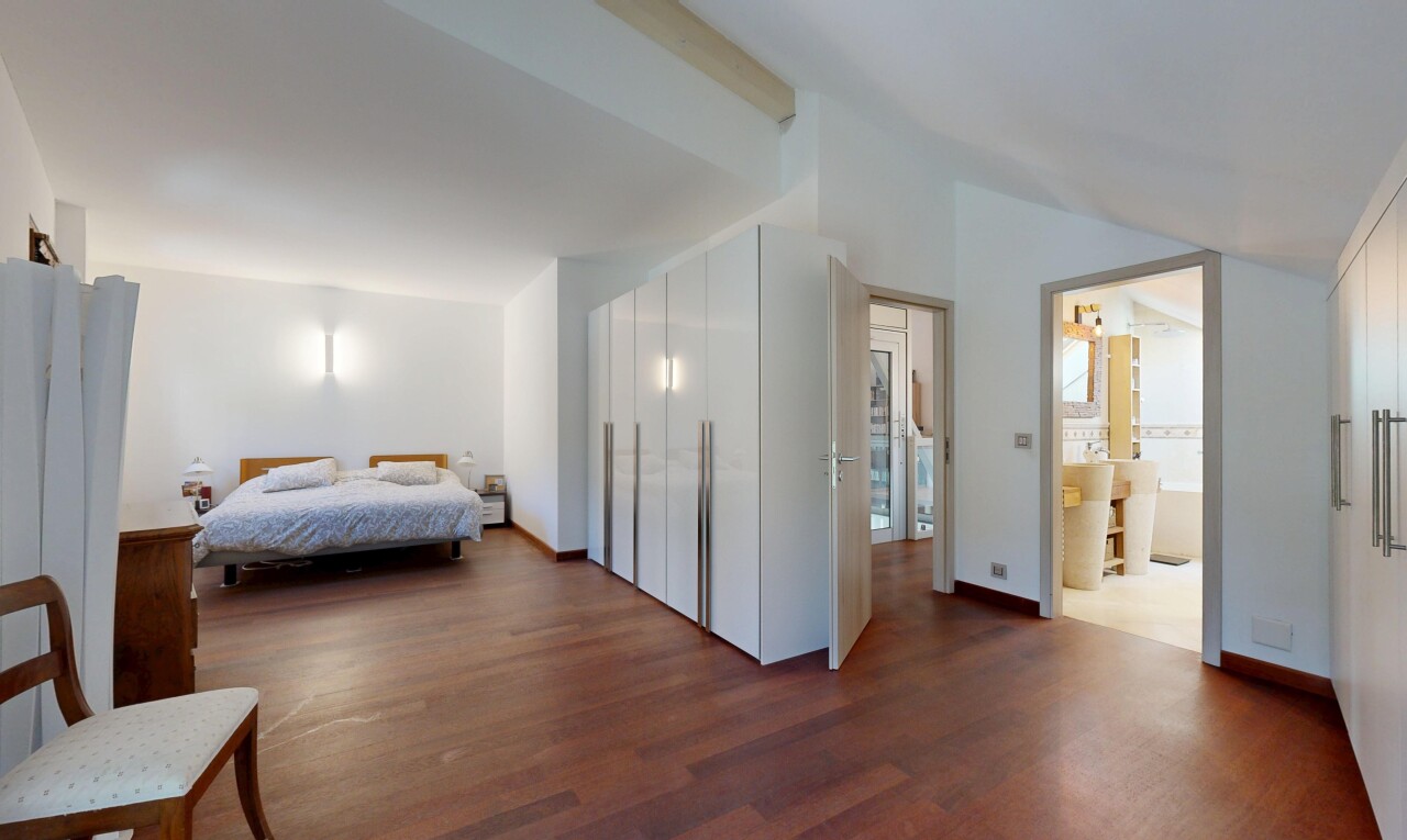 room featuring dark wood-style floors, lofted ceiling, and baseboards