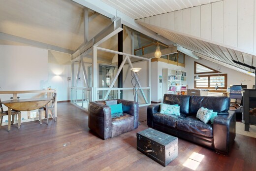 living room with vaulted ceiling with beams and wood finished floors