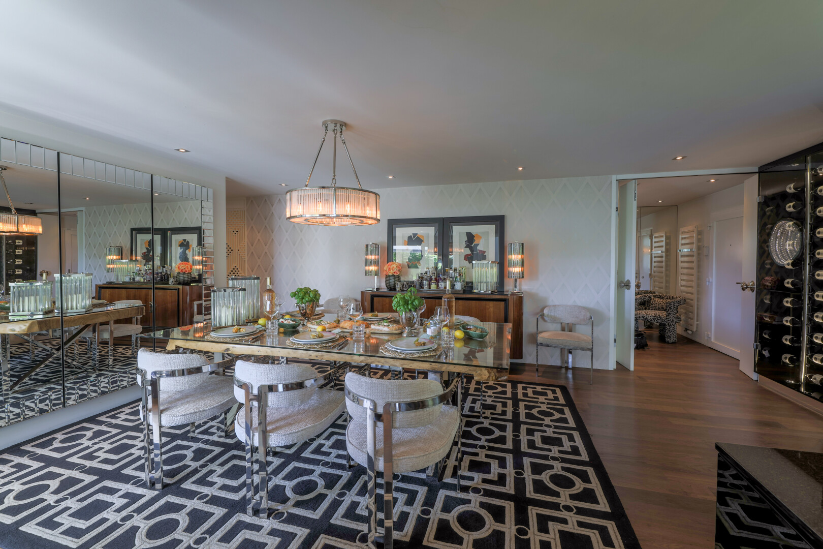 salle à manger avec inside property, wood finish floor, sol en finition bois, lustre remarquable, et dark floor