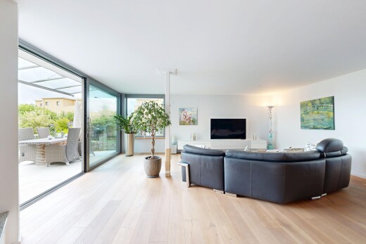 living room with expansive windows and light wood finished floors