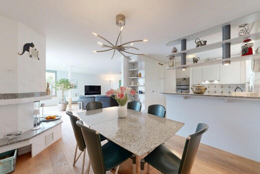 dining area with light wood-style floors and hanging lights