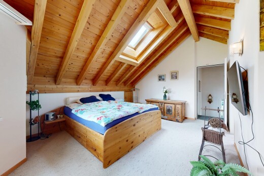 carpeted room featuring a skylight and a wooden ceiling with exposed beams