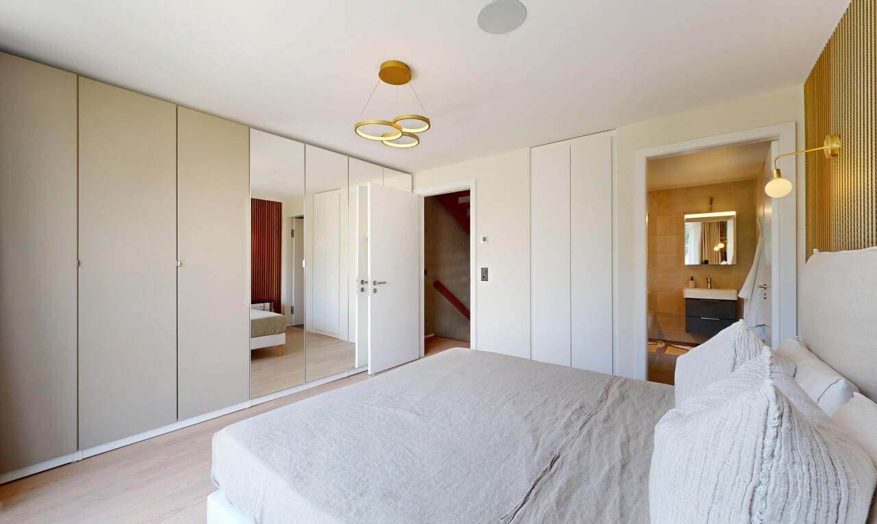 chambre avec placard, sol en finition bois, wood finish floor, inside property, et light floor
