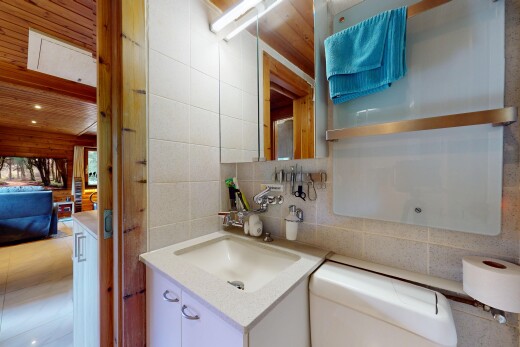 kitchen featuring tile walls, white cabinets, light countertops, and backsplash