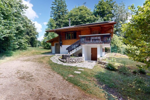 view of home featuring stairs, driveway, a garage, and a deck