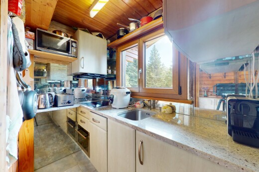 kitchen with stainless steel microwave and light stone countertops