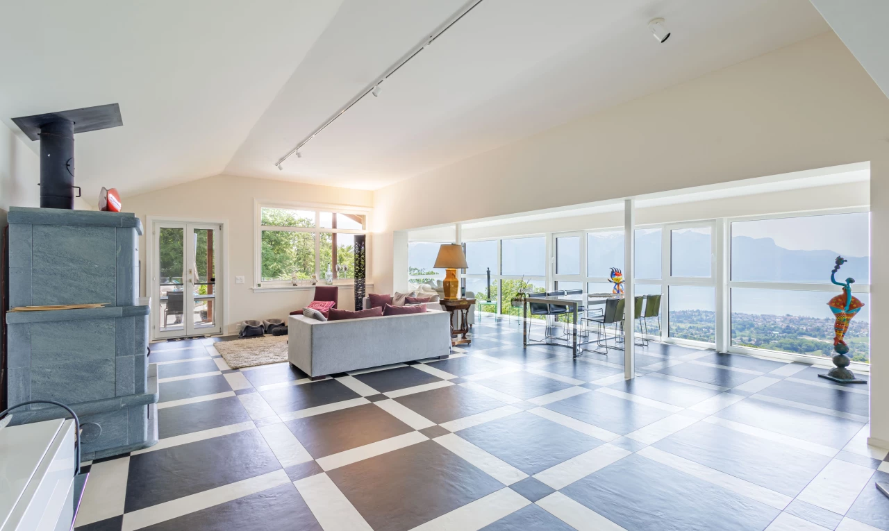 tiled living room featuring lofted ceiling and natural light