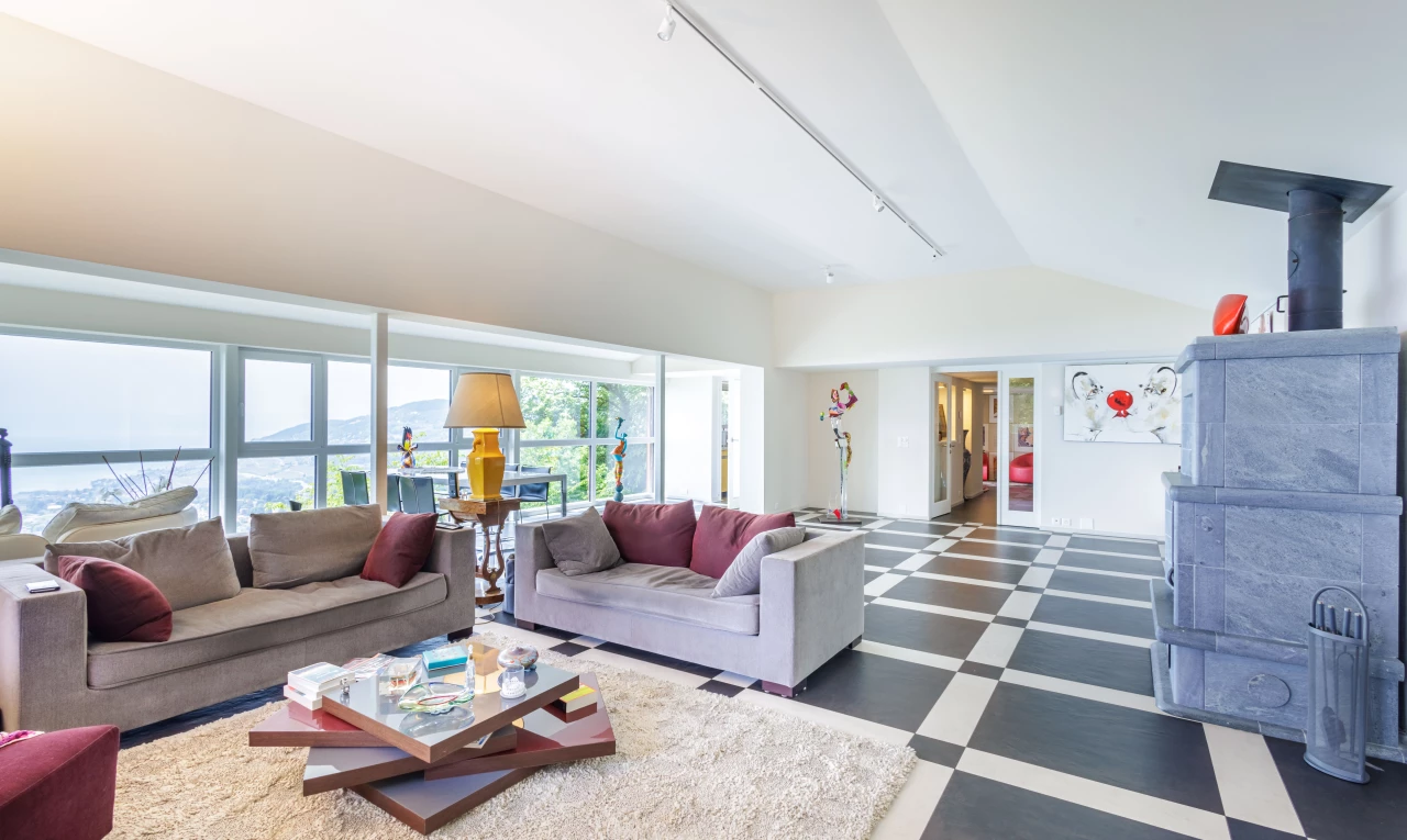 tiled living room featuring vaulted ceiling and natural light