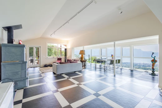 tiled living room featuring lofted ceiling and natural light