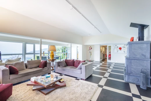 tiled living room featuring vaulted ceiling and natural light