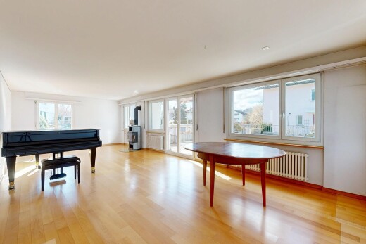 living / dining area with light wood-style floors and radiator heating unit