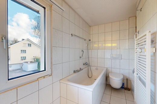 bathroom with a towel warming rack, radiator, tile walls, light tile patterned flooring, and tiled shower / bath combo
