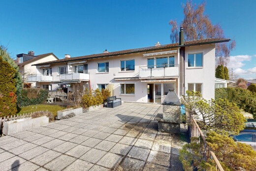 outdoor house with stucco siding, a balcony, and a patio area