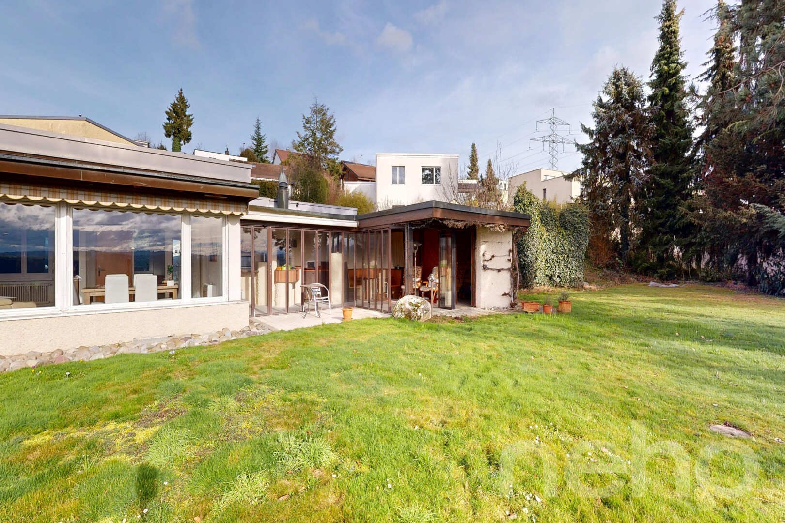 outdoor house featuring a lawn and a patio