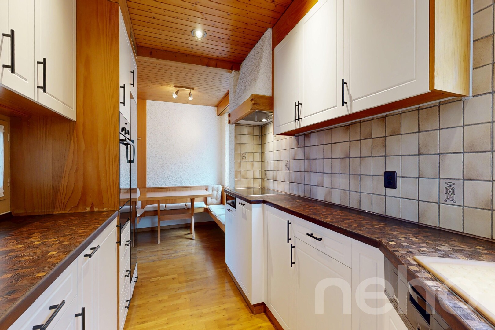 kitchen with dark countertops, white cabinetry, light wood-style flooring, tasteful backsplash, and wood ceiling