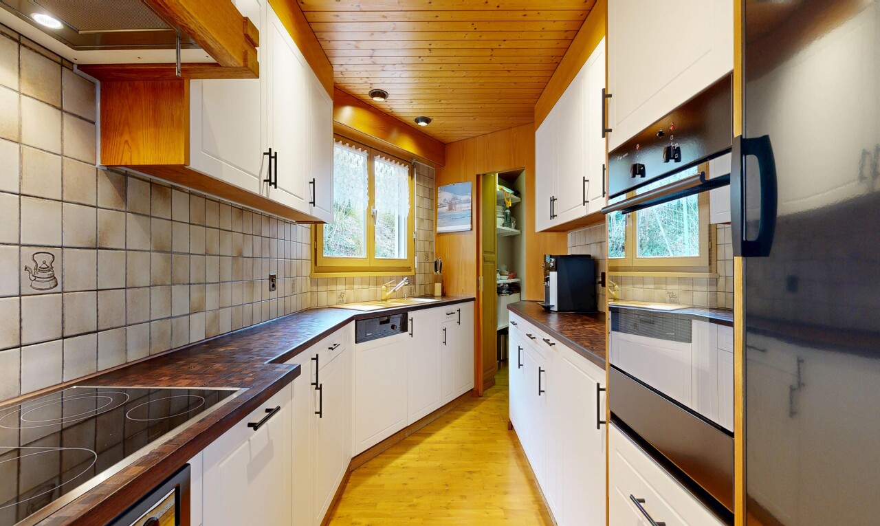kitchen featuring dark countertops, black appliances, white cabinets, and wooden ceiling