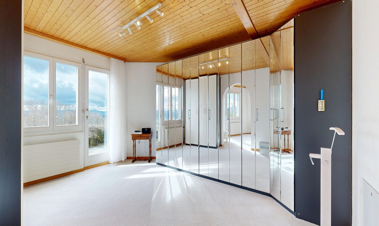 spare room featuring rail lighting, wooden ceiling, and light colored carpet