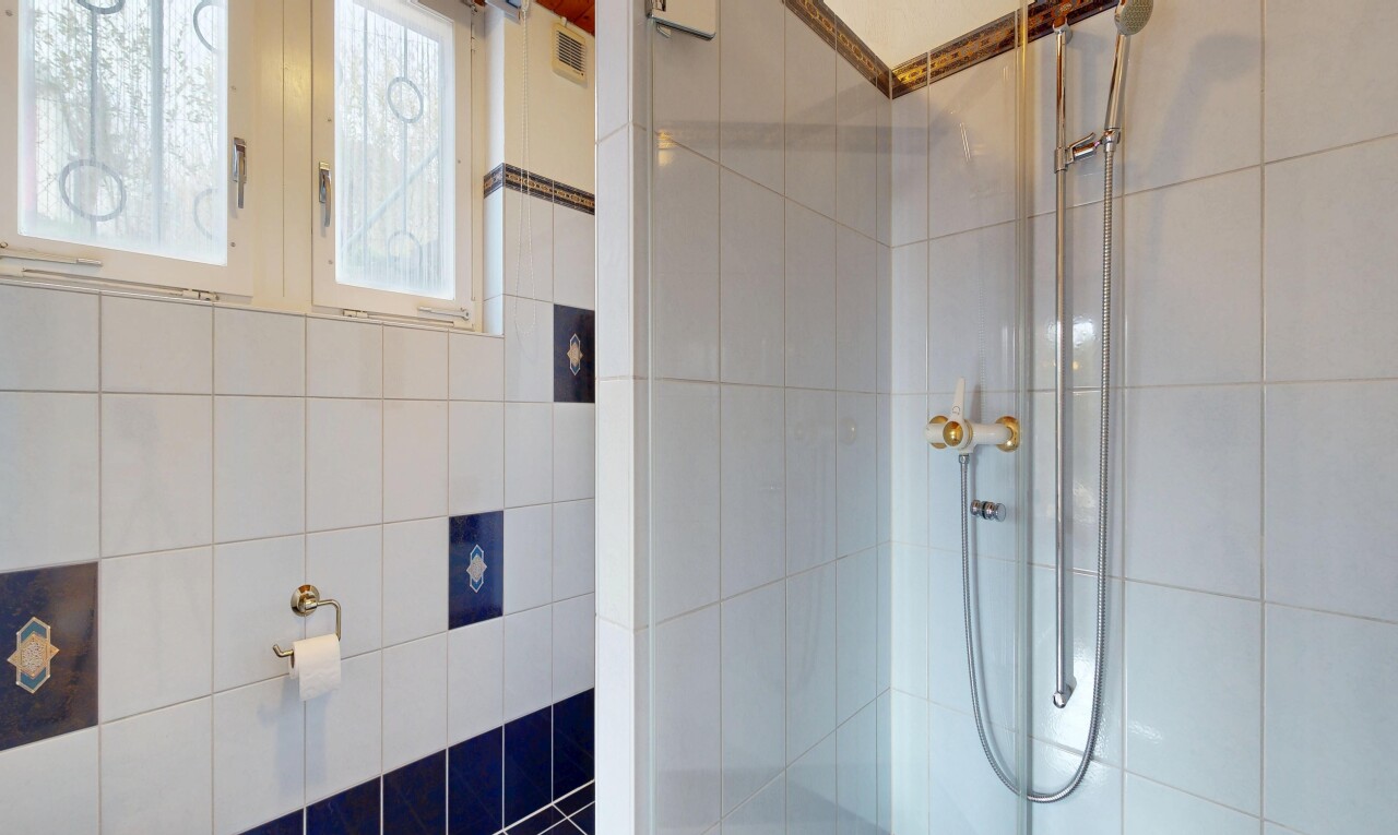 bathroom with tiled shower