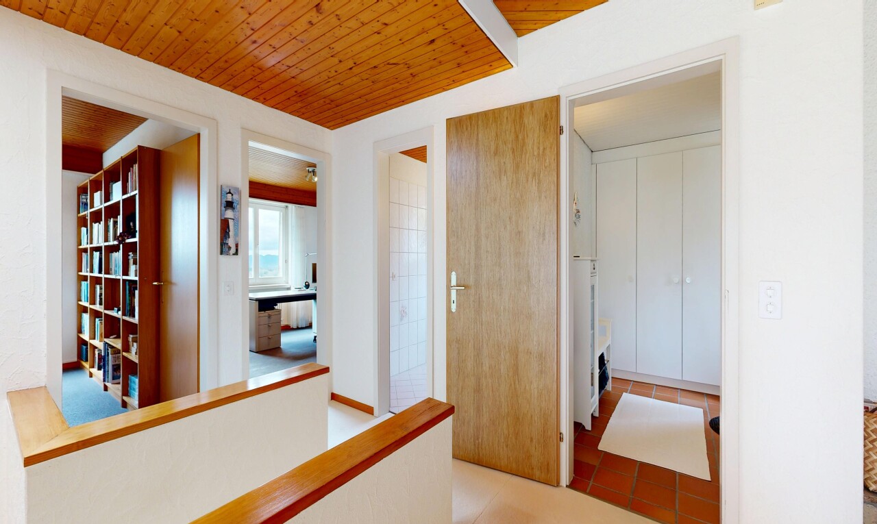corridor featuring wood ceiling and light tile patterned floors