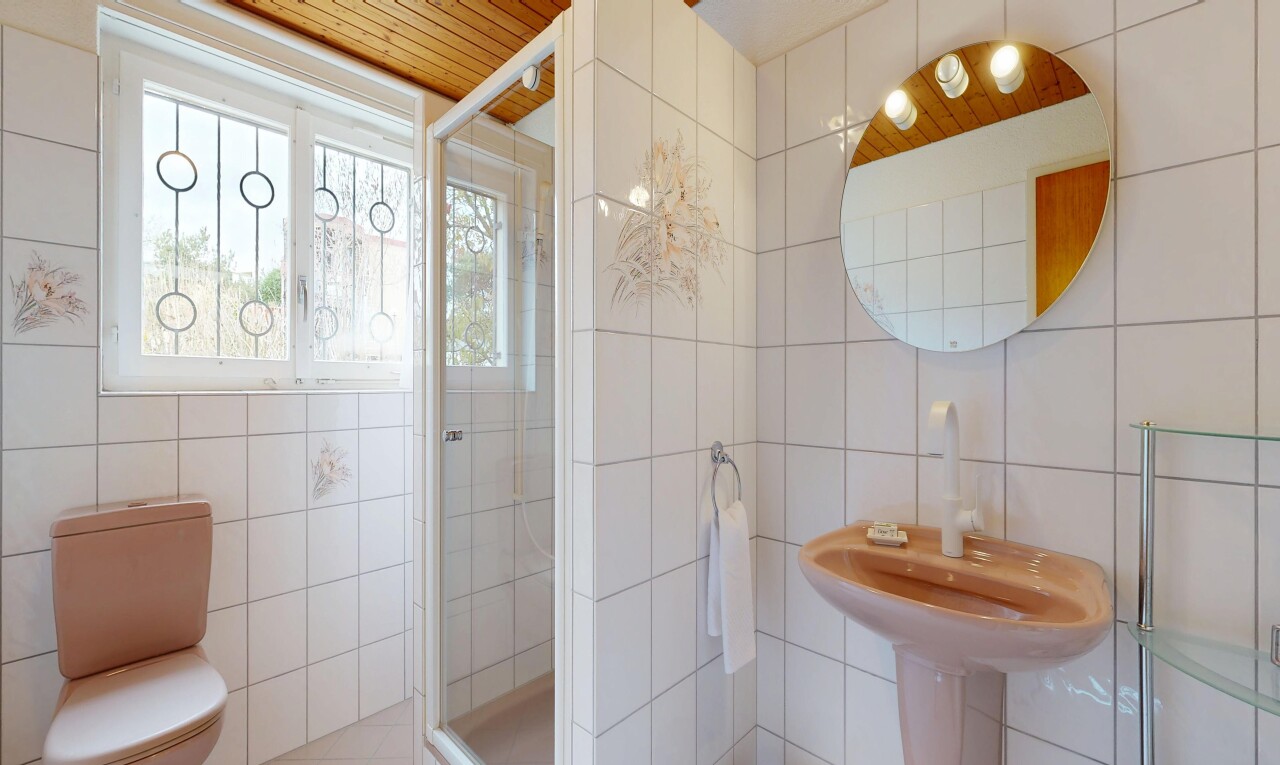 full bathroom featuring tile walls, a shower stall, and wood ceiling